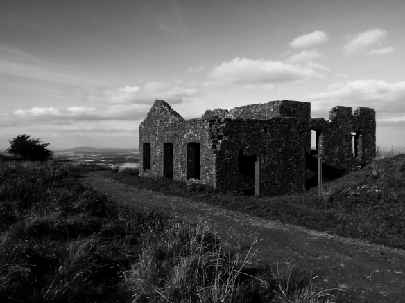 Abandoned building on Brown Clee Hill, with The Wrekin on the horizon.